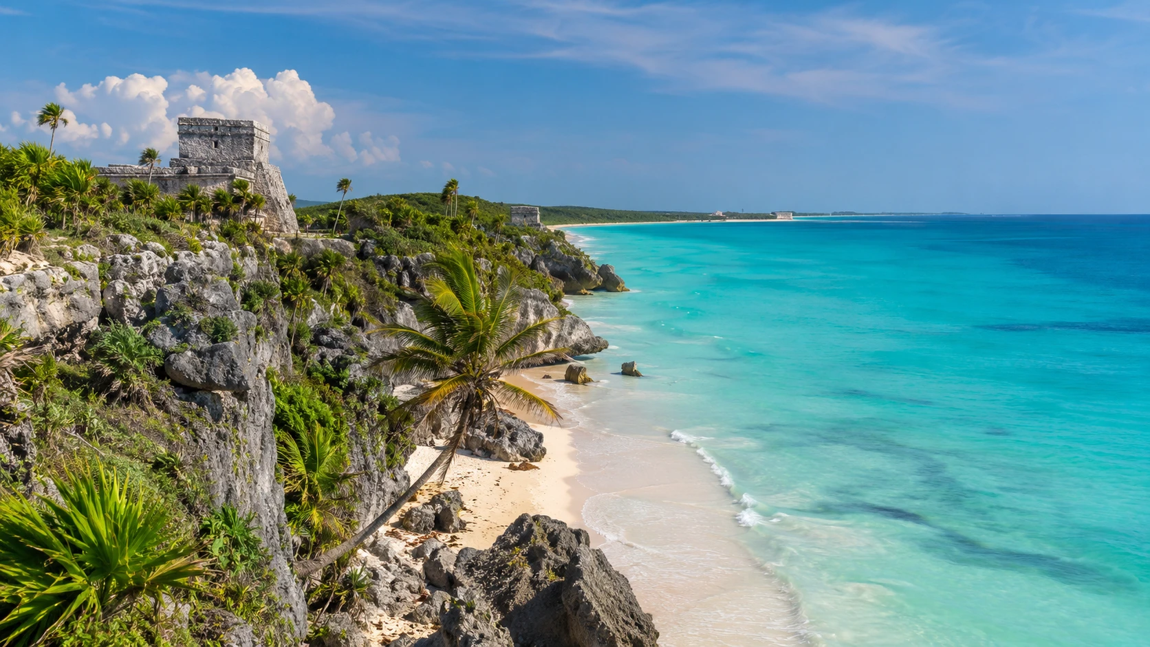 Ancient Tulum ruins on a cliff overlooking turquoise Caribbean water